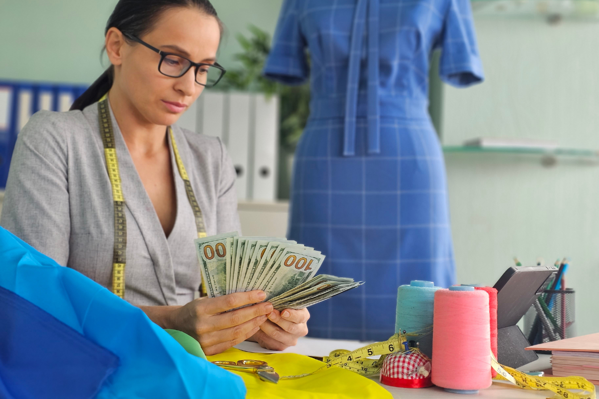 woman counting cash from side hustle DIY Craft Warehouse